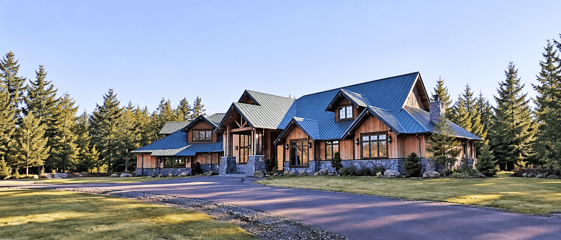 Craftsman-style home exterior with natural stone masonry pillars and chimney, built by Meister Masonry