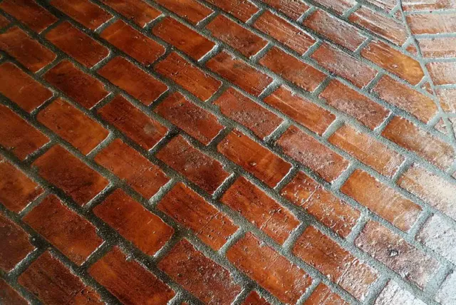Service cleaning and sealing brick surfaces
